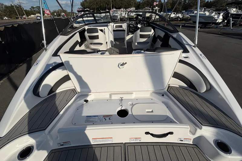 Slide: The Image of 2022 Yamaha Boats SX195 interior with open storage compartment, sleek seating, and modern design. - 12