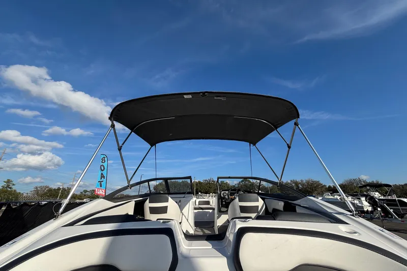 Slide: The Image of 2022 Yamaha Boats SX195 with canopy under clear blue sky. - 13