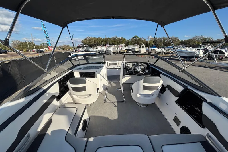 Slide: The Image of 2022 Yamaha Boats SX195 interior with seating and steering wheel, displayed outdoors. - 20