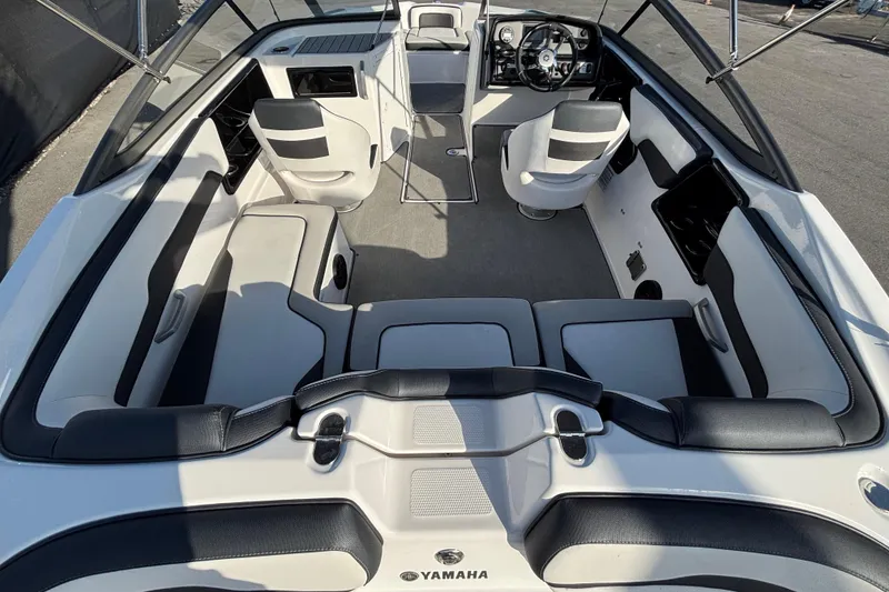 Slide: The Image of 2022 Yamaha Boats SX195 interior with sleek seating and modern dashboard design. - 21
