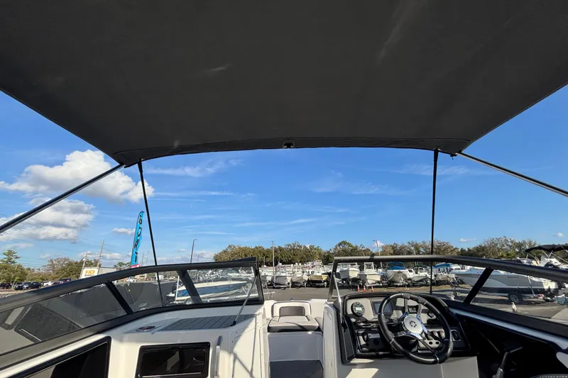 Slide: The Image of 2022 Yamaha Boats SX195 cockpit view with canopy, showcasing steering and dashboard. - 22