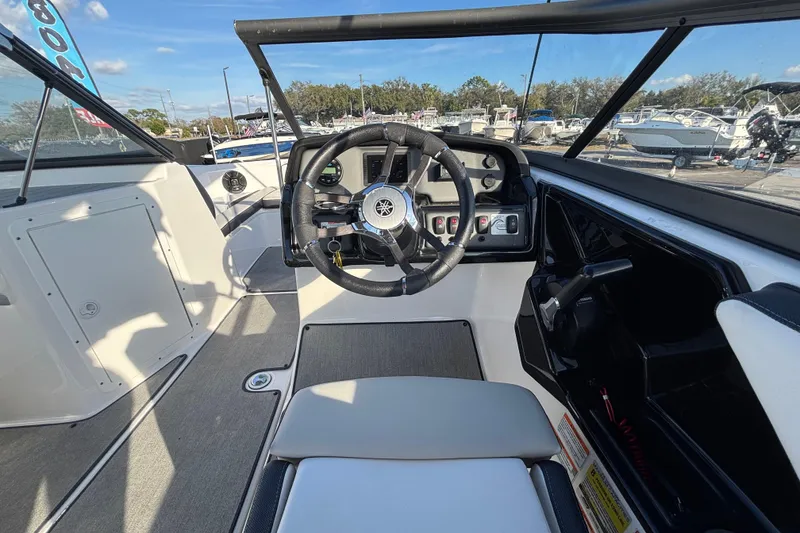 Slide: The Image of 2022 Yamaha Boats SX195 cockpit with steering wheel and dashboard controls. - 25