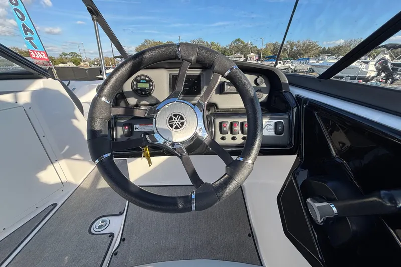 Slide: The Image of 2022 Yamaha Boats SX195 steering wheel and dashboard, featuring modern controls and design. - 26