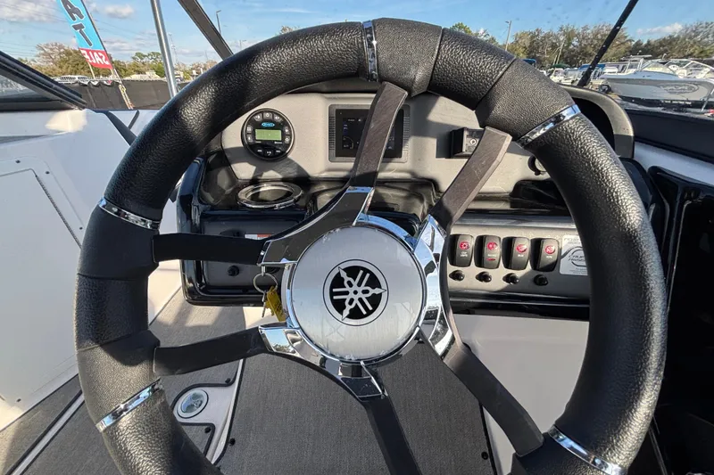 Slide: The Image of Steering wheel of 2022 Yamaha Boats SX195, showcasing dashboard controls and sleek design. - 28
