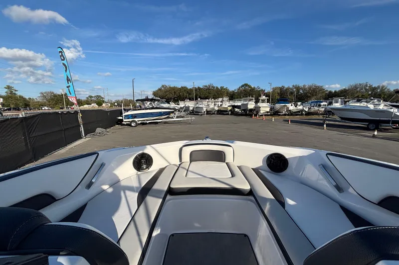 Slide: The Image of 2022 Yamaha Boats SX195 interior view at a boat dealership under a clear blue sky. - 40