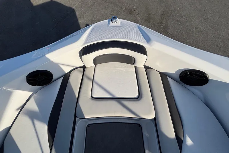 Slide: The Image of 2022 Yamaha Boats SX195 bow seating area with speakers and cushioned seats. - 45