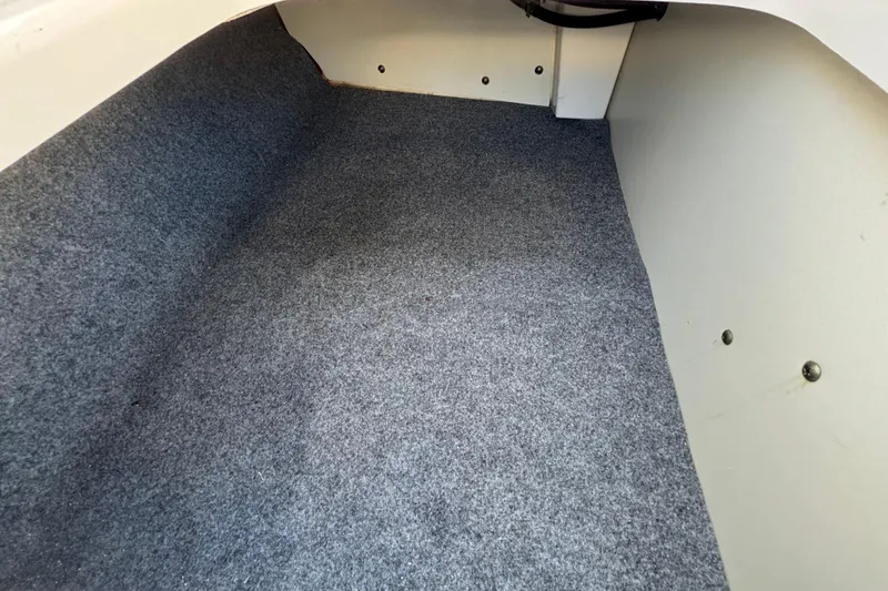 Slide: The Image of Carpeted storage area in 2022 Yamaha Boats SX195. - 59