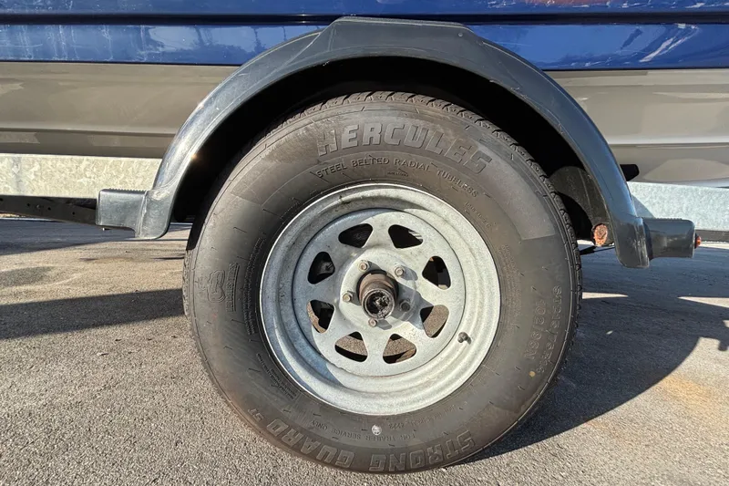 Slide: The Image of Trailer wheel of 2022 Yamaha Boats SX195, featuring Hercules tire on pavement. - 66