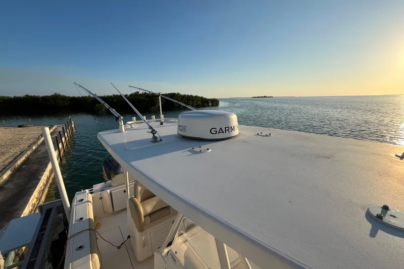 Slide: The Image of 2014 Cobia 296 Center Console boat docked at sunset with Garmin equipment. - 5