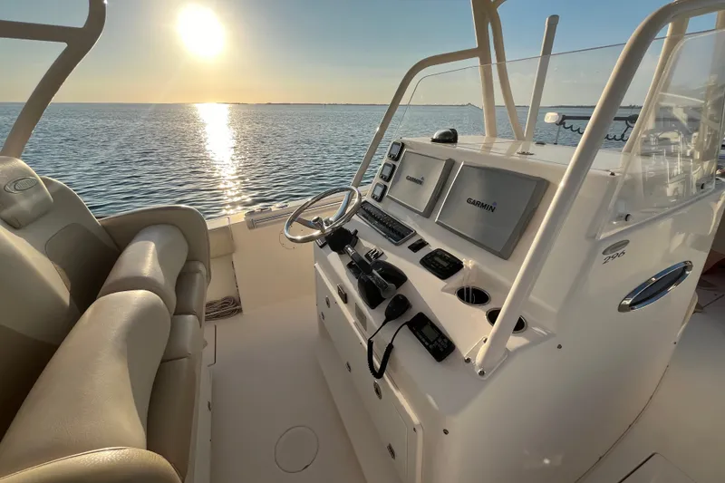 Slide: The Image of 2014 Cobia 296 Center Console boat interior with sunset over water. - 7