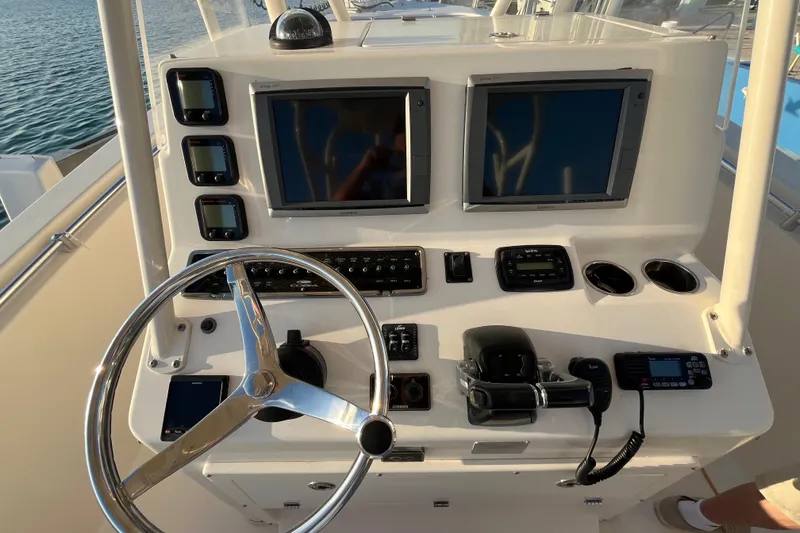 Slide: The Image of 2014 Cobia 296 Center Console helm with dual displays and navigation controls. - 8