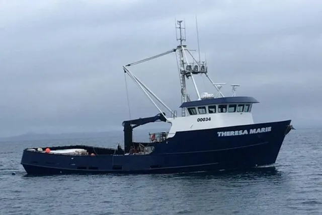 The Image of Custom 1974 Steel Cannery Tender boat on calm sea under cloudy sky. - 0