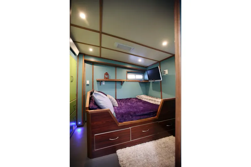Slide: The Image of Cozy bedroom in 1974 Custom Steel Cannery Tender with modern decor and ambient lighting. - 11