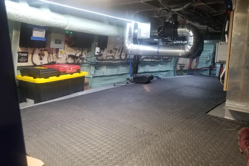 Slide: The Image of Interior of a 1974 Custom Steel Cannery Tender with equipment and storage boxes. - 14