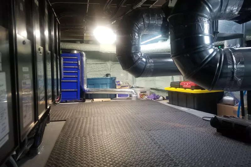 Slide: The Image of Industrial workspace with ductwork, tool storage, and equipment, featuring a 1974 Custom Steel Cannery Tender. - 15