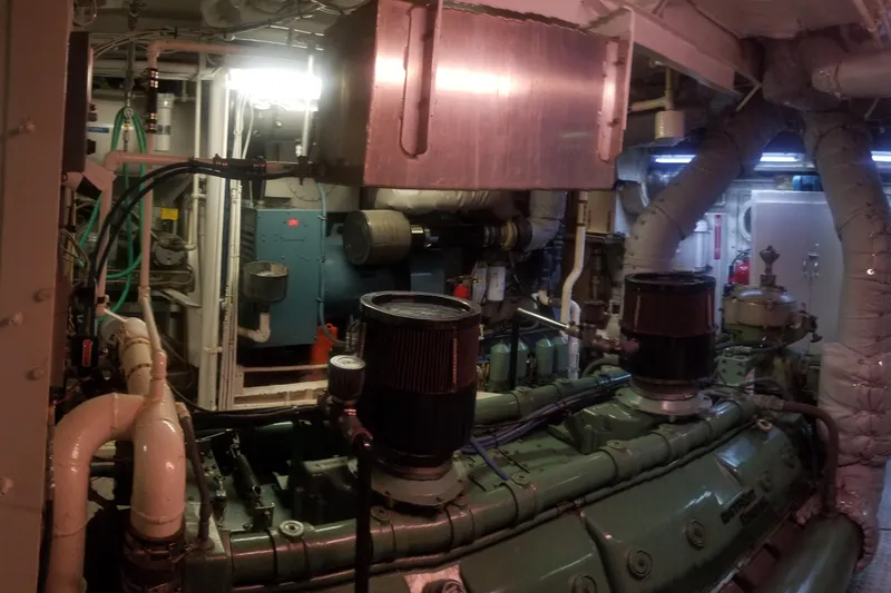 Slide: The Image of Engine room of a 1974 Custom Steel Cannery Tender, showcasing machinery and piping. - 18