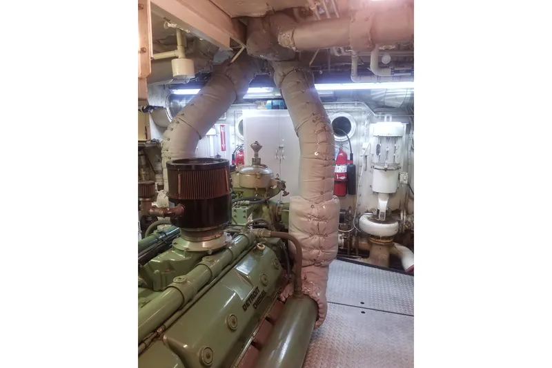 Slide: The Image of Engine room of a 1974 Custom Steel Cannery Tender with visible machinery and piping. - 19