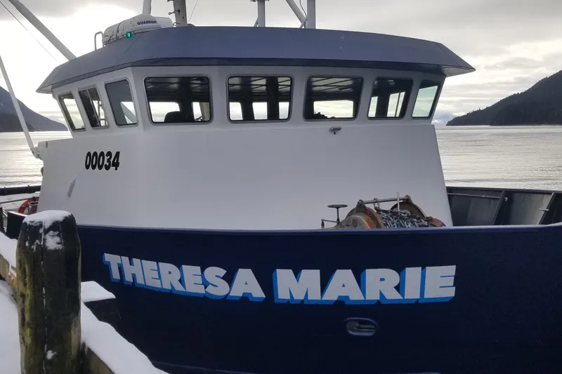 Slide: The Image of 1974 Custom Steel Cannery Tender "Theresa Marie" docked by snowy pier. - 2