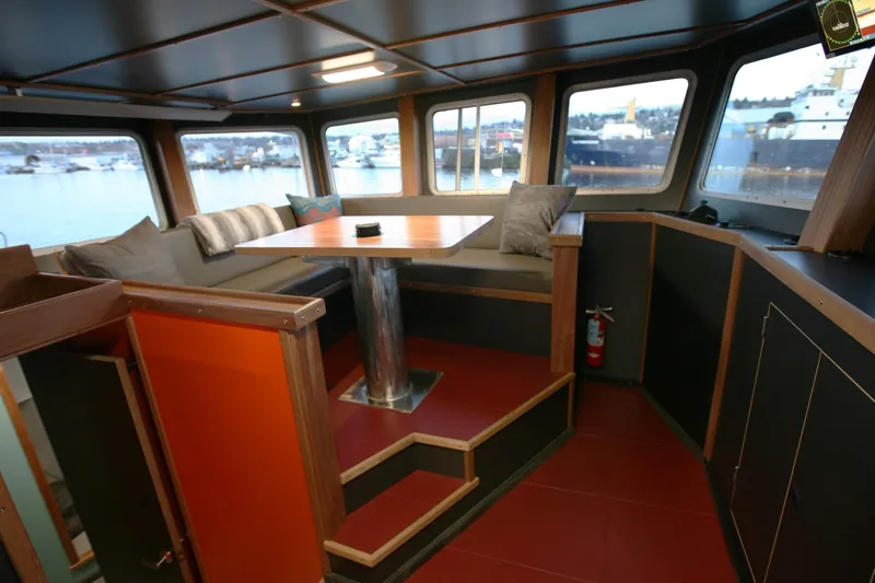 Slide: The Image of Interior of a 1974 Custom Steel Cannery Tender with cozy seating and panoramic windows. - 3