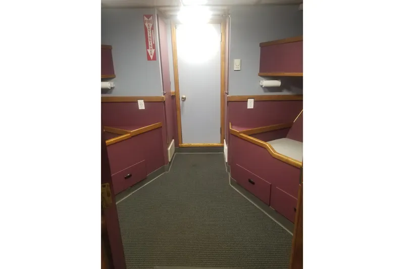 Slide: The Image of Interior of a 1974 Custom Steel Cannery Tender with purple seating and fire extinguisher sign. - 9