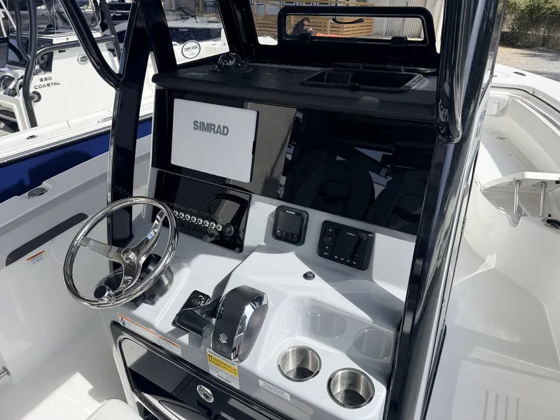 Slide: The Image of Interior view of 2026 Sea Pro 242 DLX boat with Simrad controls. - 10