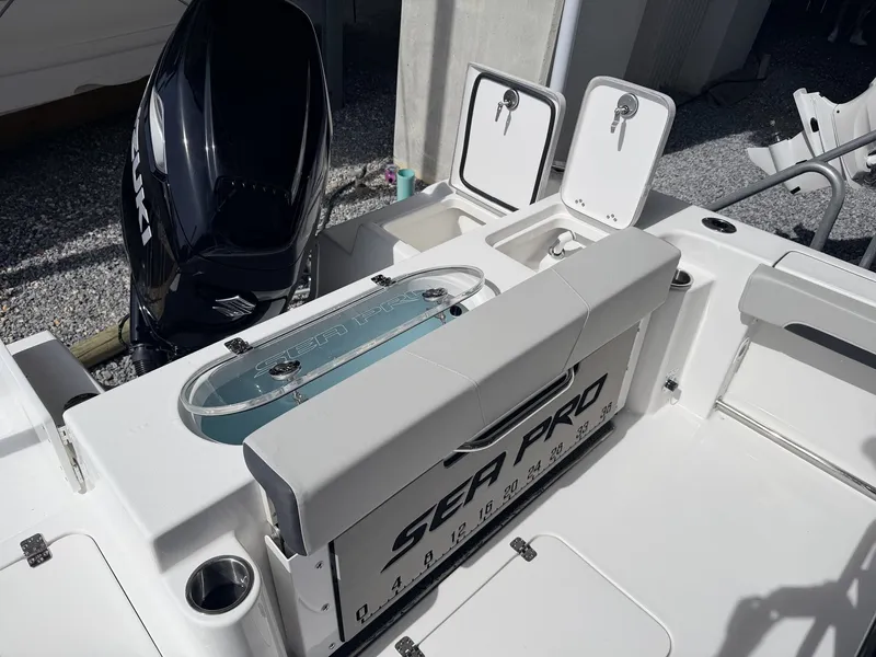 Slide: The Image of 2026 Sea Pro 242 DLX boat with Suzuki engine and storage compartments. - 14
