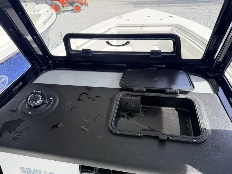 Slide: The Image of Interior view of Sea Pro 242 DLX 2026 with compass and storage compartment. - 9