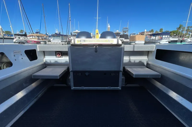 Slide: The Image of 2017 Stabicraft 2500 Ultracab XL boat interior at marina, showcasing seating and cabin entrance. - 17