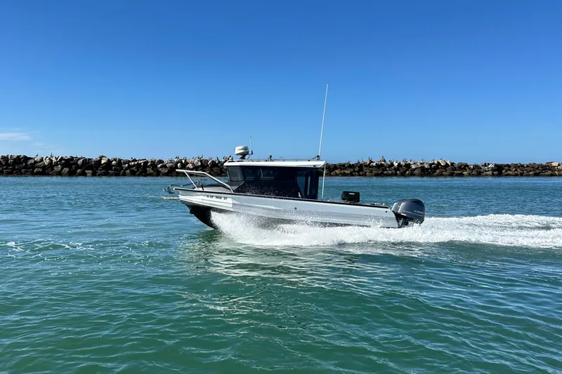 Slide: The Image of 2017 Stabicraft 2500 Ultracab XL boat on calm water near rocky shoreline. - 2