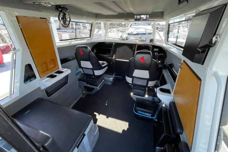 Slide: The Image of 2017 Stabicraft 2500 Ultracab XL boat interior with grill and colorful kayaks. - 24