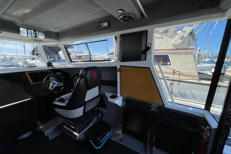 Slide: The Image of Interior view of 2017 Stabicraft 2500 Ultracab XL boat with dual seats and steering wheel. - 29