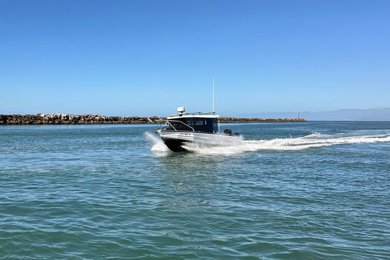 Slide: The Image of 2017 Stabicraft 2500 Ultracab XL boat on calm water, featuring dual outboard motors. - 4