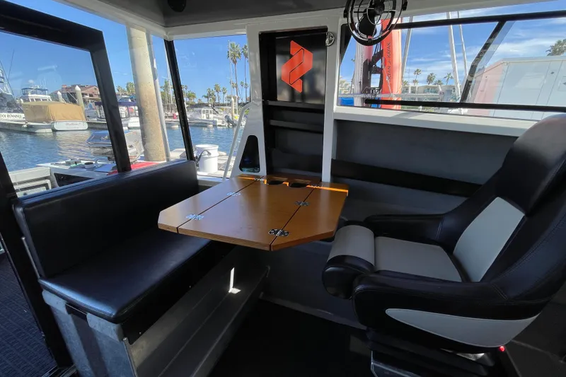 Slide: The Image of Interior of 2017 Stabicraft 2500 Ultracab XL, featuring seating and storage, docked at marina. - 47