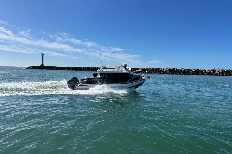 Slide: The Image of 2017 Stabicraft 2500 Ultracab XL boat on calm water, featuring dual outboard motors. - 5