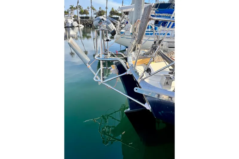 Slide: The Image of Cape George 36 sailboat, 1975 model, docked with clear water reflection. - 12