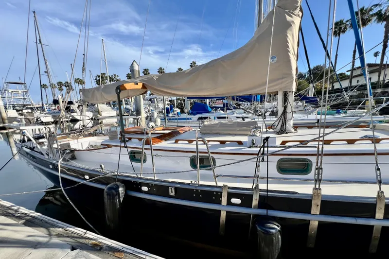 Slide: The Image of 1975 Cape George 36 sailboat docked in a marina, featuring classic design and rigging. - 14