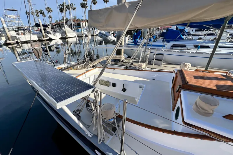 Slide: The Image of 1975 Cape George 36 sailboat with solar panel, docked in a marina. - 18