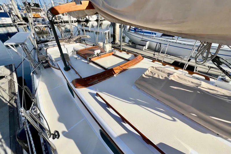 Slide: The Image of 1975 Cape George 36 sailboat deck with wooden accents docked at marina. - 19