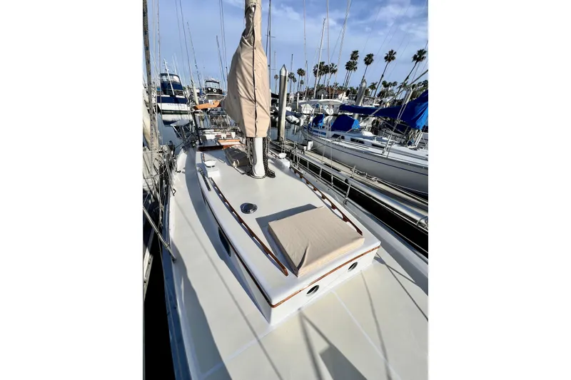 Slide: The Image of 1975 Cape George 36 sailboat docked, featuring a clean deck and covered mast. - 20