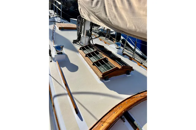 Slide: The Image of 1975 Cape George 36 sailboat deck with wooden details and covered mast. - 28