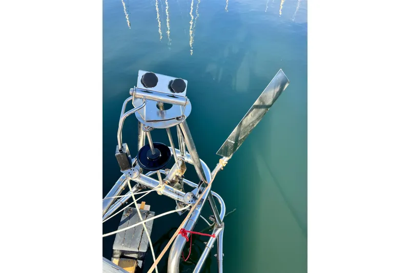 Slide: The Image of Close-up of a 1975 Cape George 36 sailboat's wind vane against calm water. - 31