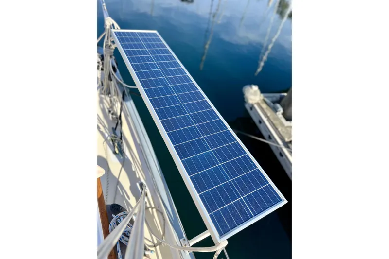 Slide: The Image of Solar panel on a 1975 Cape George 36 sailboat, docked by calm water. - 35