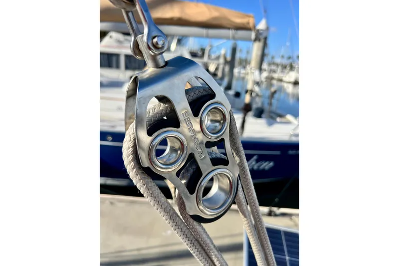 Slide: The Image of Close-up of a Cape George 36 sailboat rigging, showcasing metal pulley system. - 37