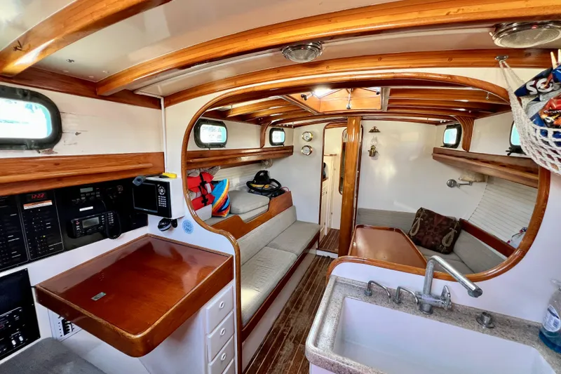 Slide: The Image of Interior of 1975 Cape George 36 sailboat with wooden accents and cozy seating area. - 42