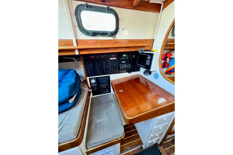 Slide: The Image of Navigation station of a 1975 Cape George 36 sailboat with wooden desk and control panels. - 43