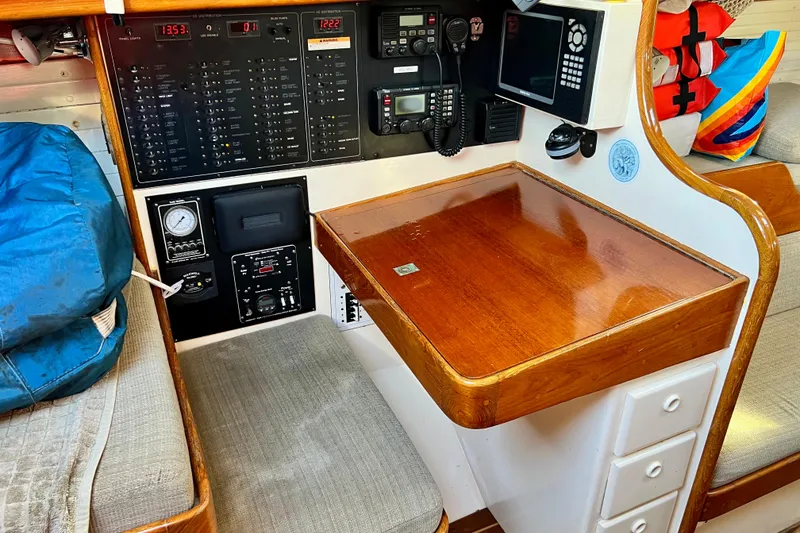 Slide: The Image of Navigation station of a 1975 Cape George 36 sailboat with control panel and wooden desk. - 44