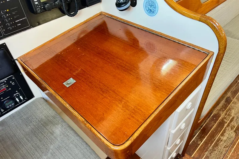 Slide: The Image of Wooden navigation desk on a 1975 Cape George 36 sailboat, featuring communication equipment. - 45