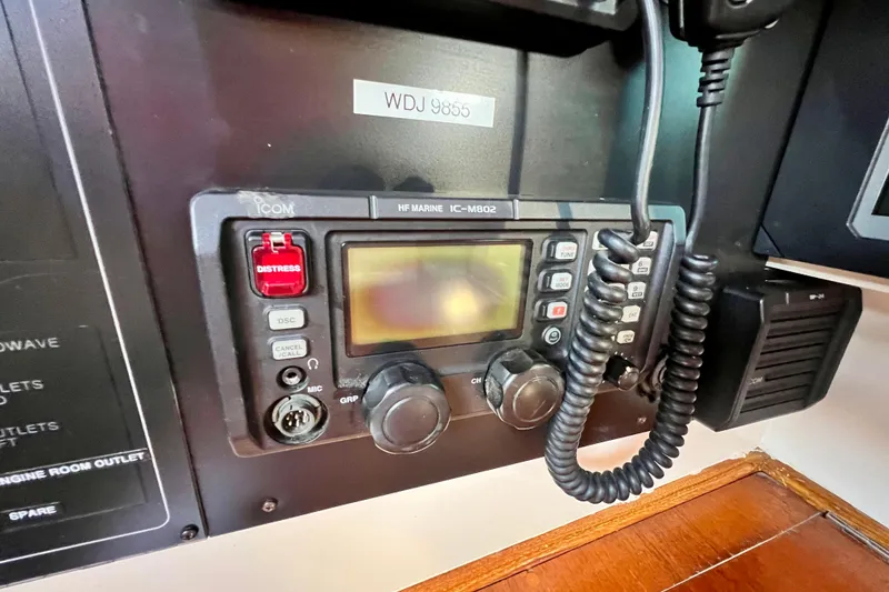 Slide: The Image of Marine radio equipment on a 1975 Cape George 36 sailboat, featuring distress and communication controls. - 50