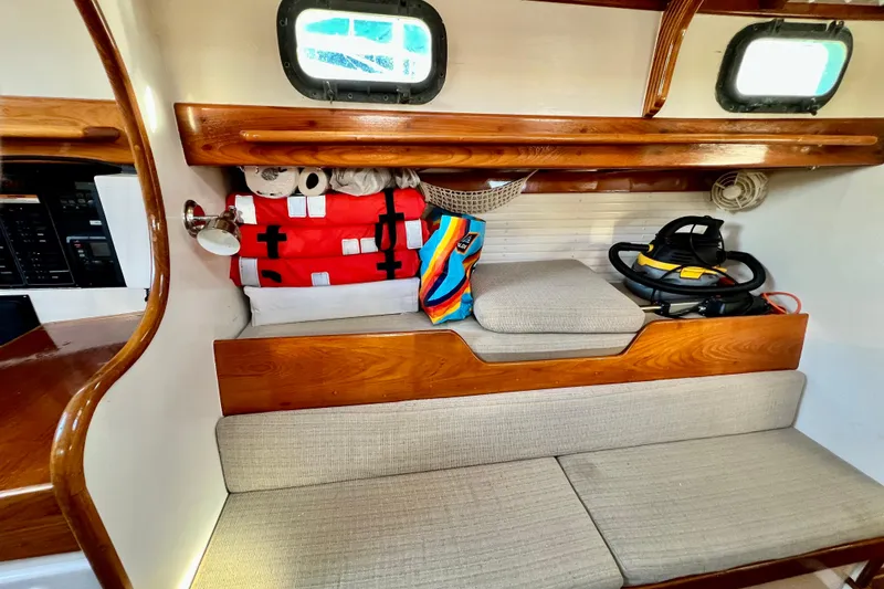 Slide: The Image of Interior of a 1975 Cape George 36 sailboat with wooden accents and storage. - 53
