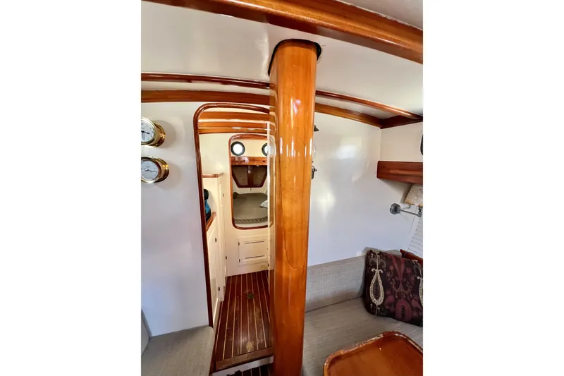 Slide: The Image of Interior of 1975 Cape George 36 sailboat with polished wood and cozy seating area. - 55